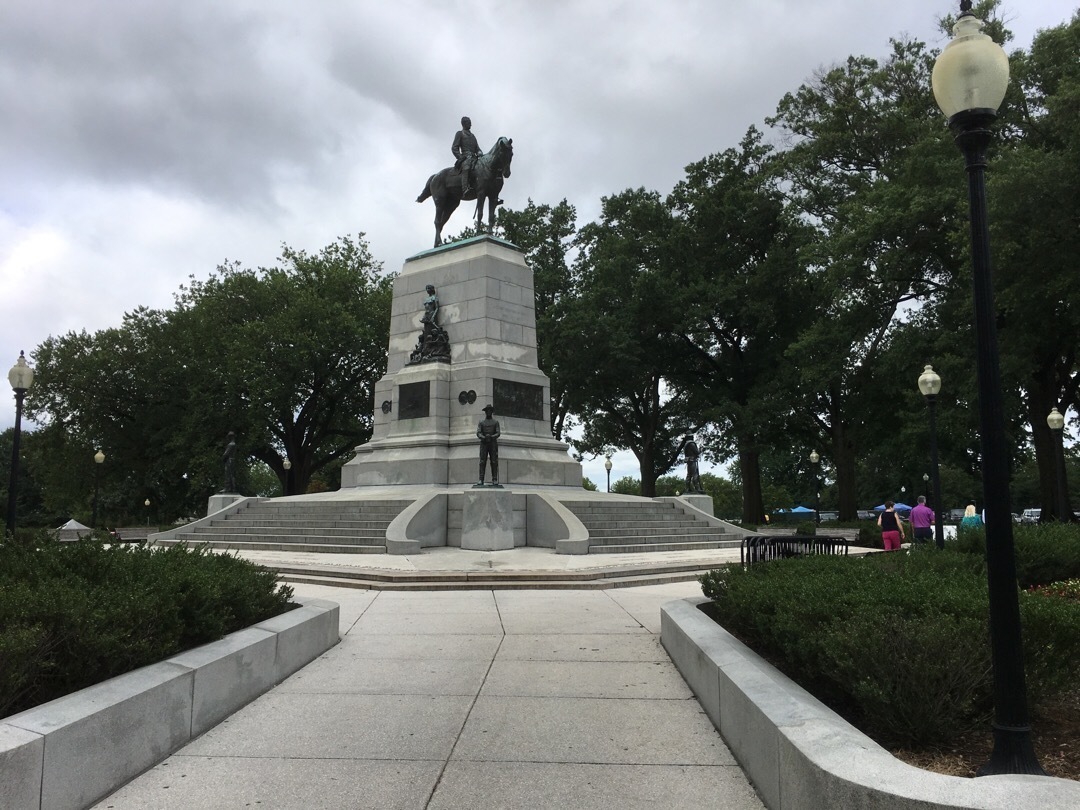 A statue of General William Tecumseh Sherman riding a horse on top of a large stone pedestal