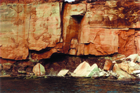 Photograph of cliff along the west shore between Twomile and Fourmile Canyons, Glen Canyon National Recreation Area. Large boulders are piled at the base of the cliff.