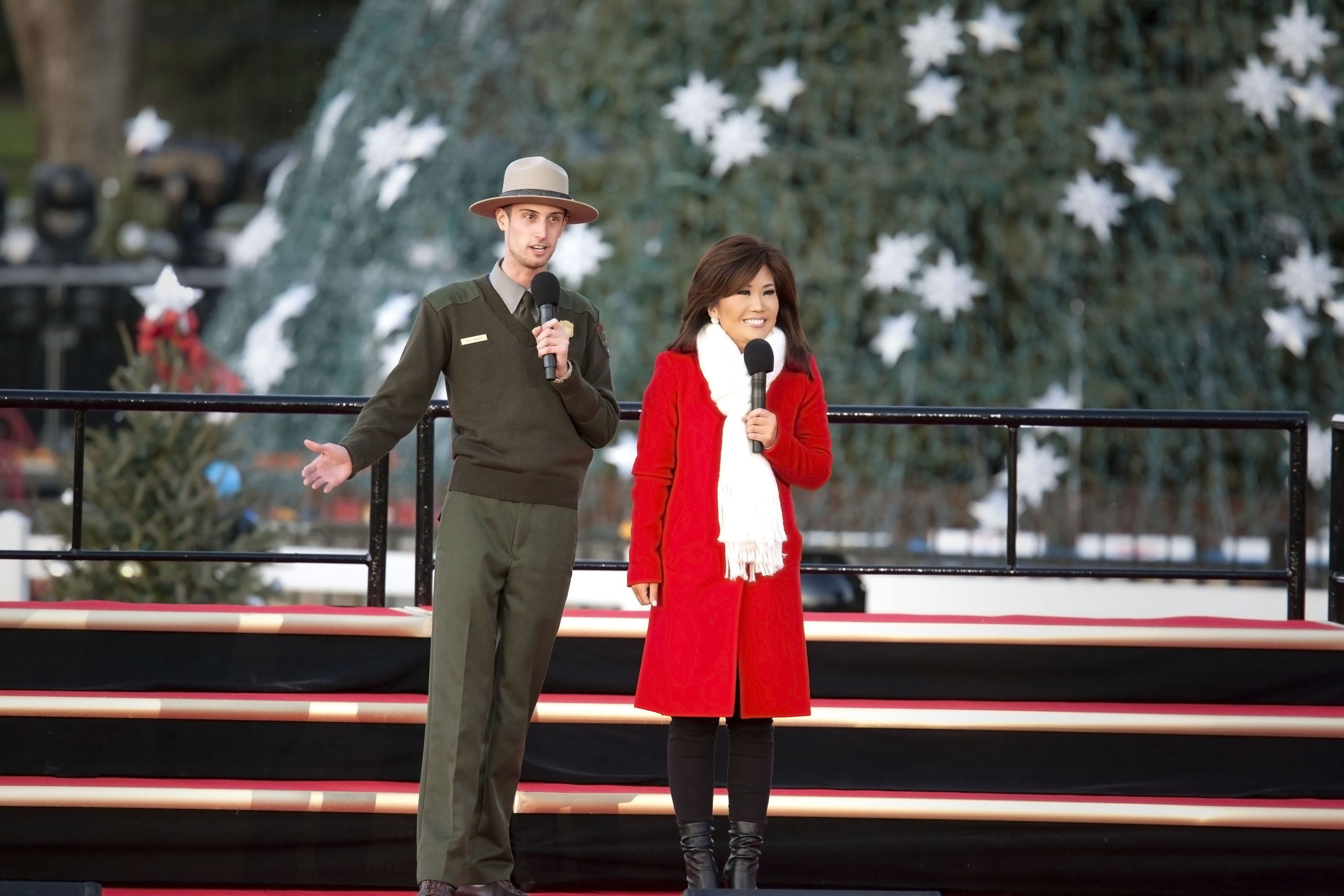 Park Ranger Kyle Yarusso and host of the pre-show Annie Yu both speak to the audience at the National Christmas Tree Lighting