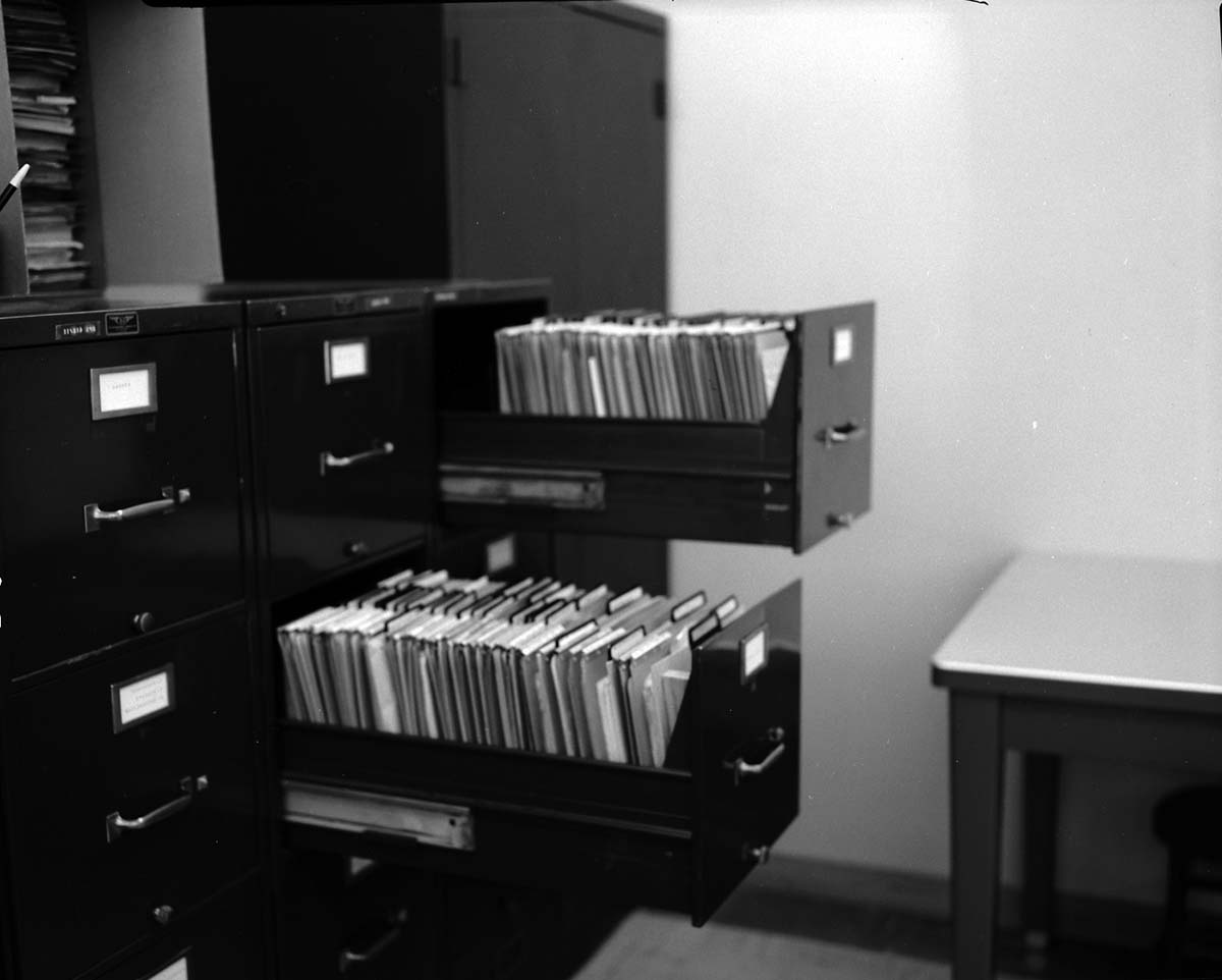 File cabinets improved by use of v-shaped block to hold file divider in place. Block suggested by Z. Brinkenhoff and made by J. Blackburn - for possible incentive award.