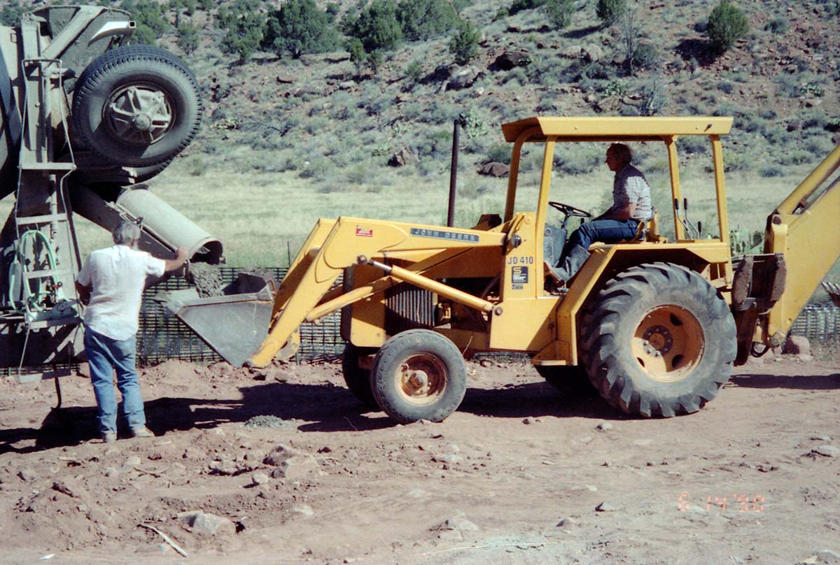 Workers operating construction vehicles during the construction of headquarters addition.