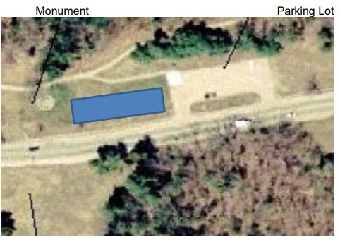 Arial photograph of the Paul Revere Capture site beside a two lane road. A blue rectangle marks the area in the center/left of the image. 