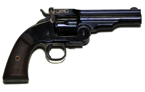 A small, dark-colored revolver laid flat against a white background.