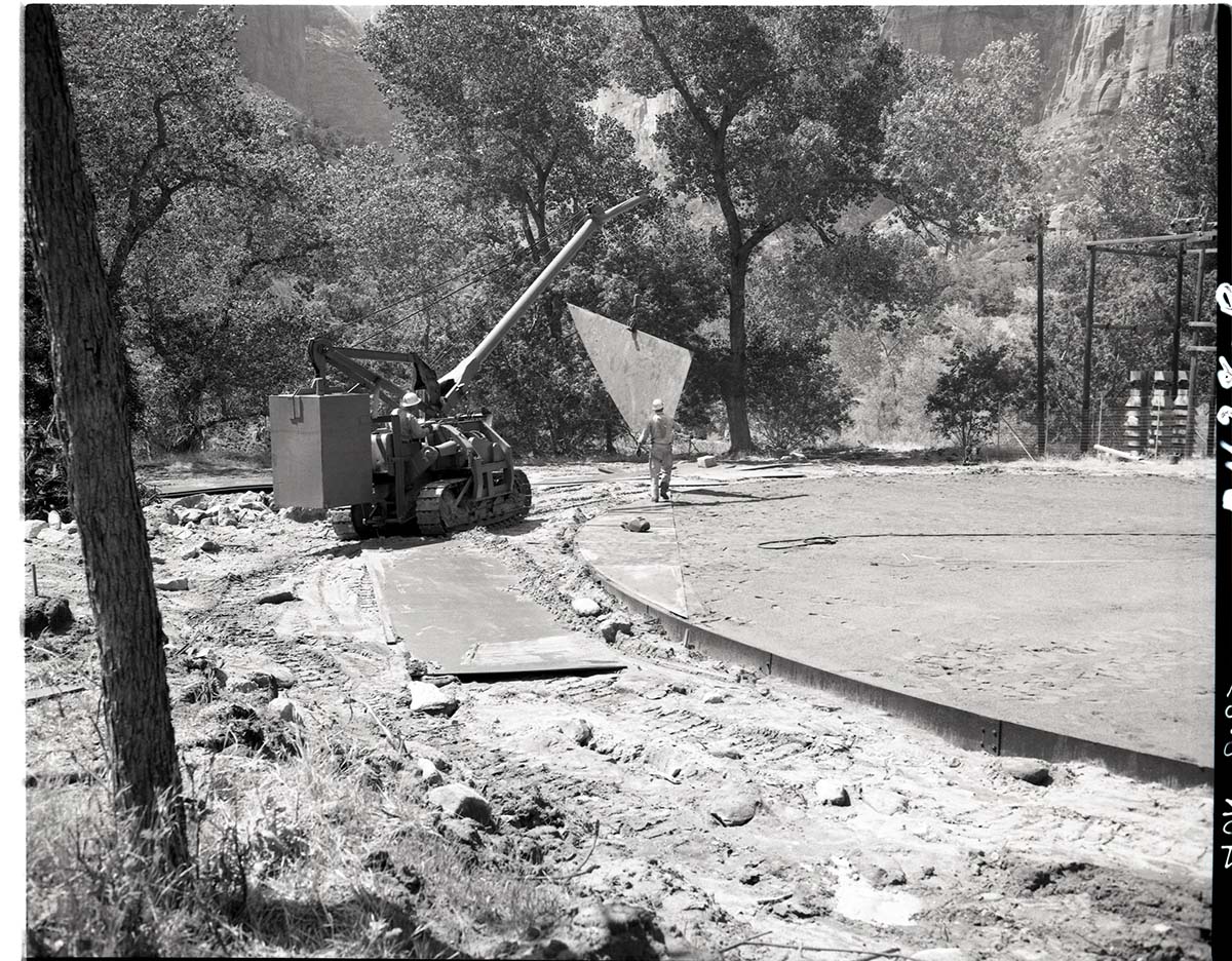 Construction of million gallon water tank at Birch Creek. Contractors are laying steel plates for floor, half the plates in place water distribution structures.