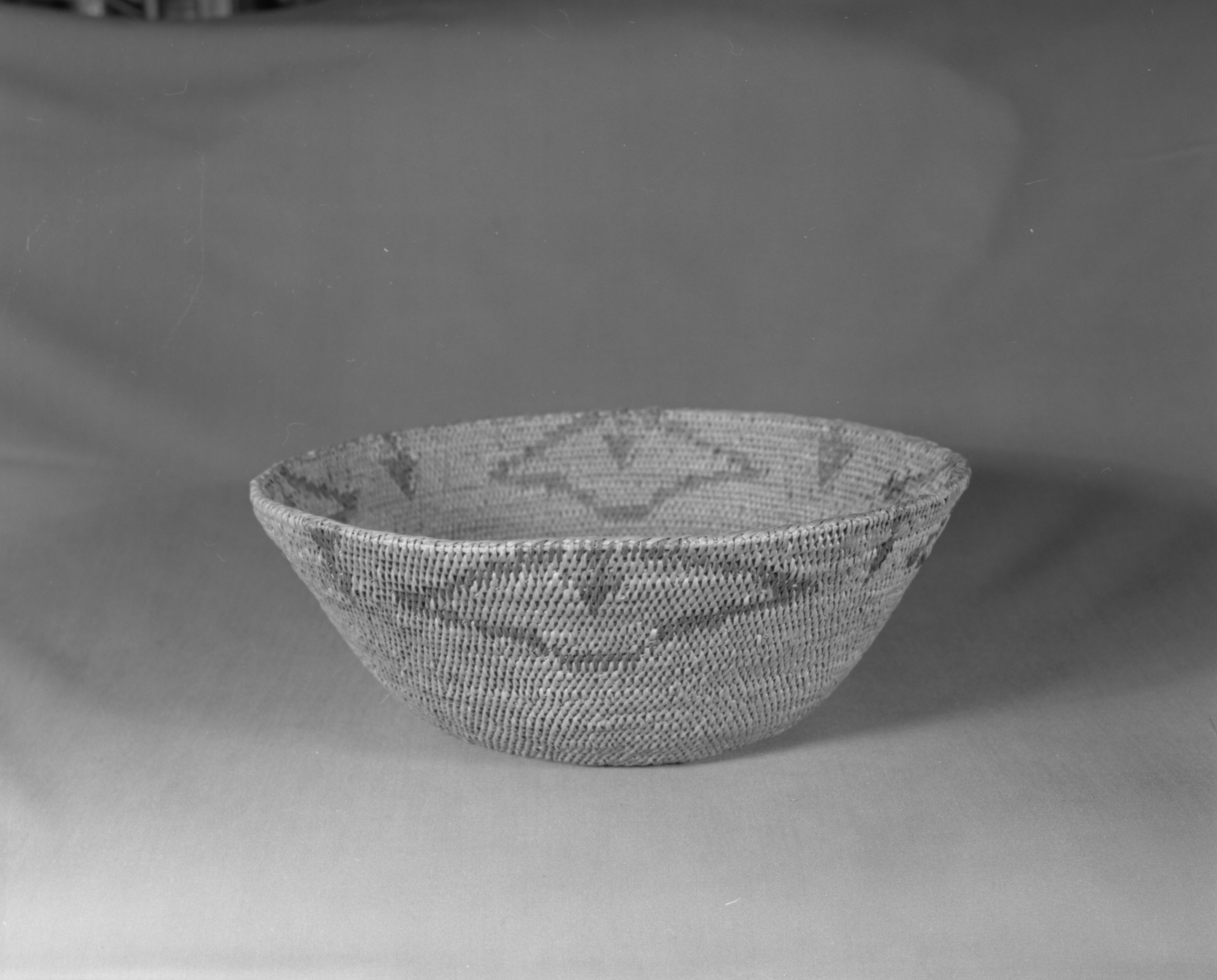 Private Collection. Object: Miwok basket. Dimensions: 12 x 4 1/2". Materials: Bull pine, redbud, and fern root. Technology: Fag ends trimmed on work face, moving ends trimmed on interior, triple overstitched rim splitting rod clockspring start, overstitched. Collection History: Probably Matilda although tag says basket acquired in Yosemite. Photographed by Michael Dixon. Catalogued by Craig Bates and Barbara Beroza. Yosemite Collections, National Park Service.