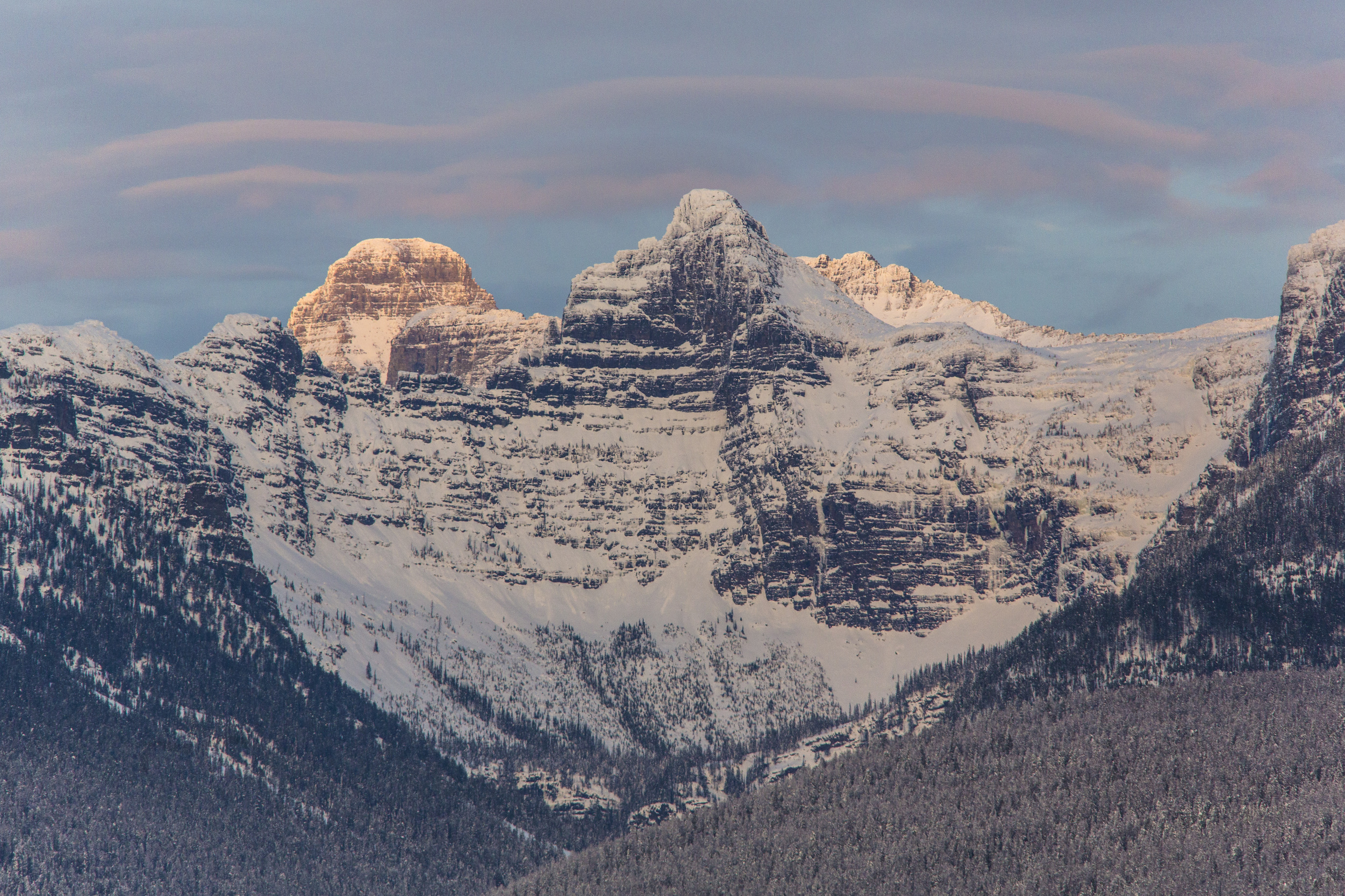 snowy jagged peaks form a mountainous wall 