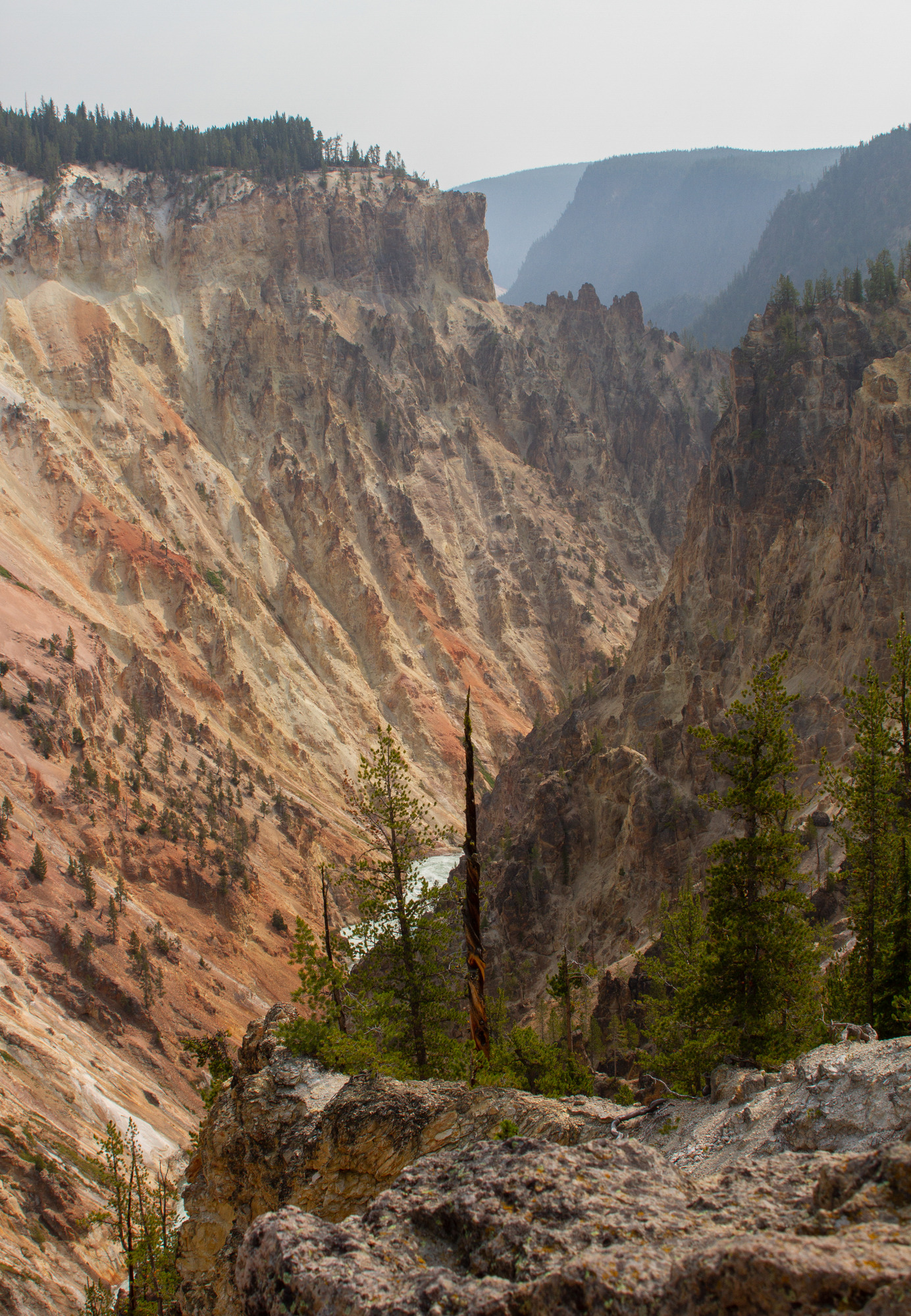 Looking through a deep canyon full of orange and pink colors.