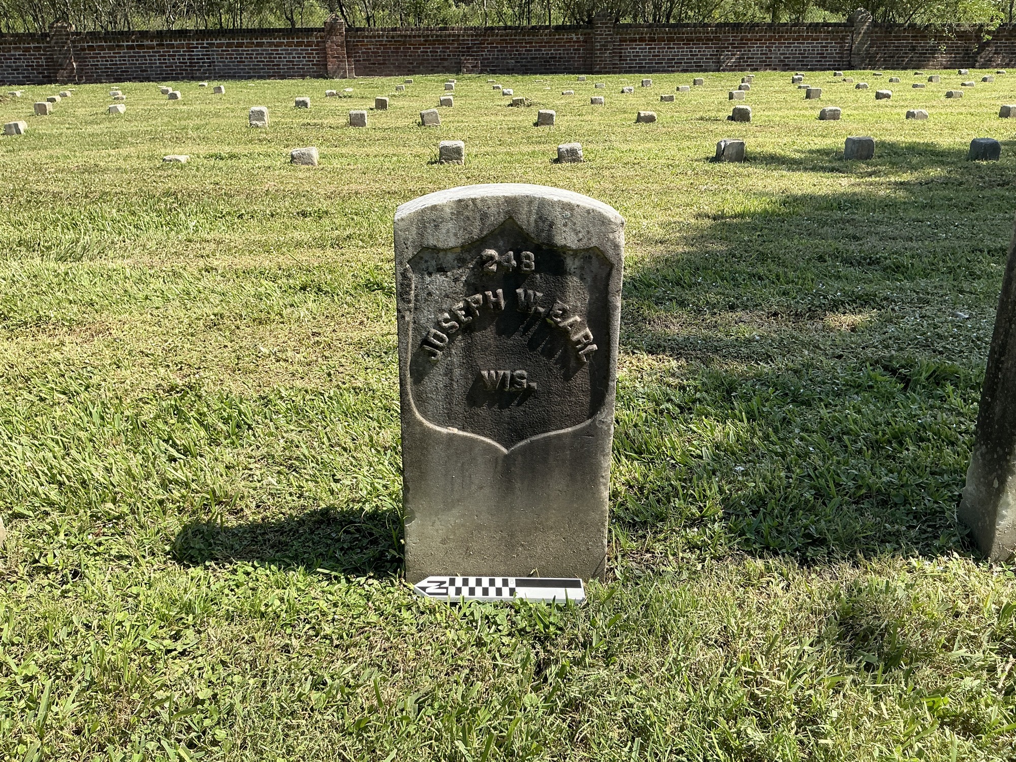 Extra image of historic upright marble headstone with recessed shield face.