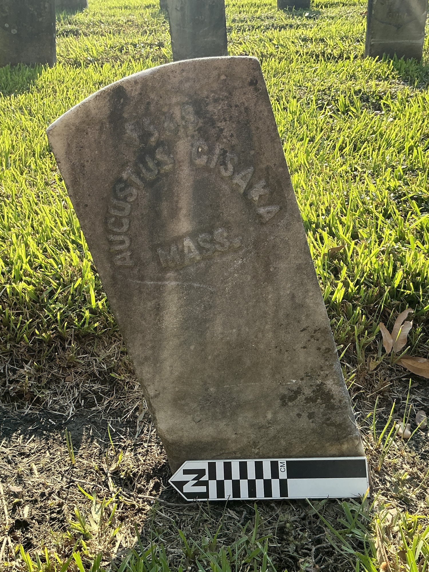 Extra image of historic upright marble headstone with recessed shield with recessed lettering face.