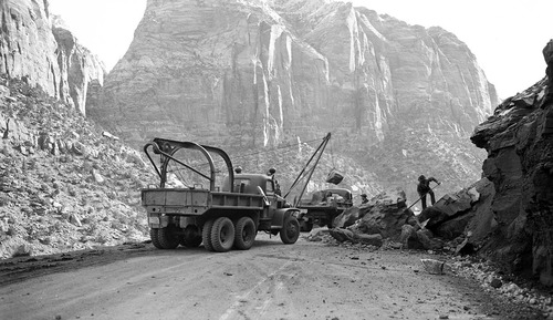 B&W negative of rock slide on Nevada switchback (Zion-Mt. Carmel Highway) vehicles and workers clearing road. [second image and positive]