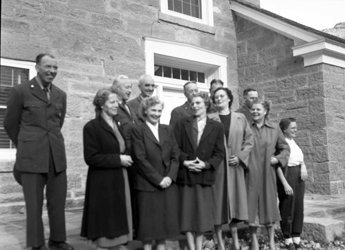 Men and women attendees of the All-Area Staff Meeting pose in front of the ranger dormitory. Meeting held at Zion National Park on December 5, 1952.