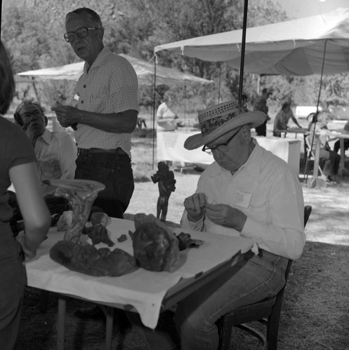 Participant, Bill Miller carving a peach pit creature at the first annual Folklife Festival, Zion National Park Nature Center, September 1977.