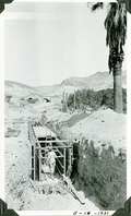 This is an historic black and white photograph from the Scotty's Castle Historic Photograph Collection, Death Valley National Park of four unidentified men working on construction of Scotty's Castle Tunnels. Tunnel in front of Hacienda basement, known as Multipurpose Facility (MPF) Tunnel. May 18, 1931. Photographed by Mat Roy Thompson.