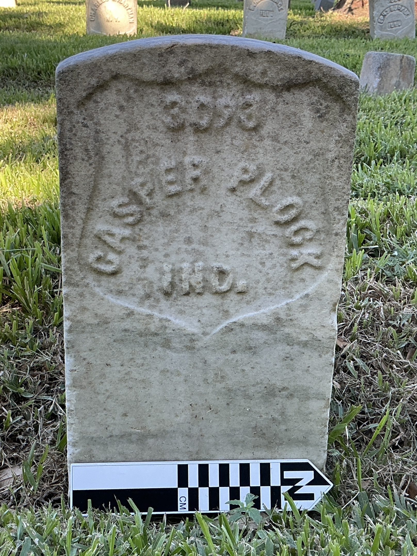 Extra image of historic upright marble headstone with recessed shield face.
