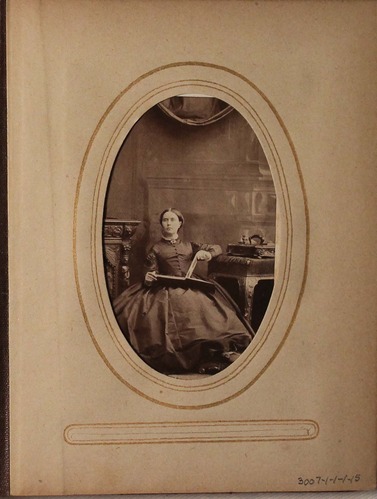 Black and white photograph of woman reading.