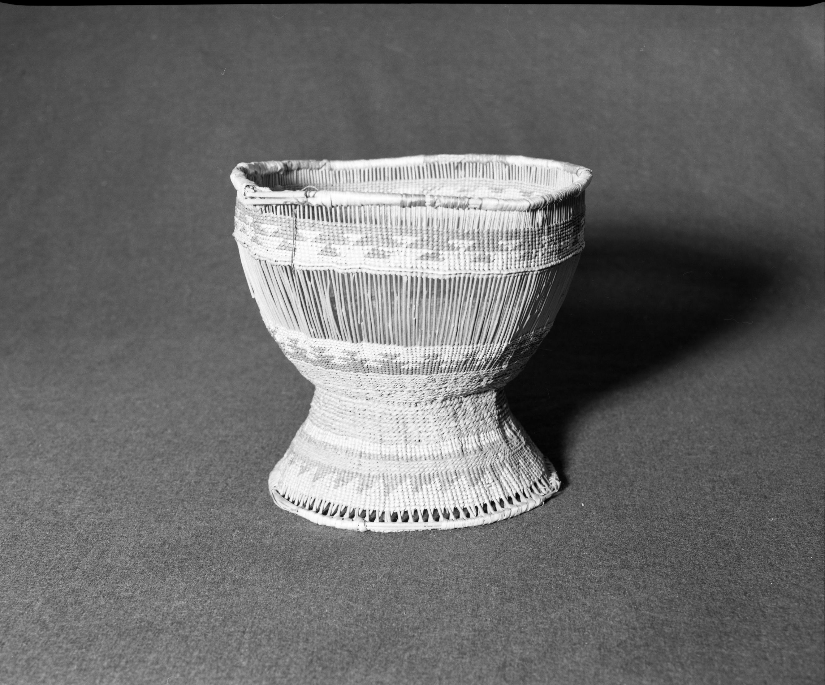 Marie Rozier Collection, Catalog No. 81. Object: Yurok/Karok/Hupa basket. Dimensions: 8 x 10". Materials: Hazel shoots, conifer root, beargrass, woodwardia fern stems dyed with alder bark. Collection History: Made for sale piece. Gift of Mrs. S. M. Long. From Mrs. Lilly Berry. Probably collected before 1900. Photographed by Michael Dixon in December 1982. Catalogued by Craig Bates and Barbara Beroza. Yosemite Collections, National Park Service.