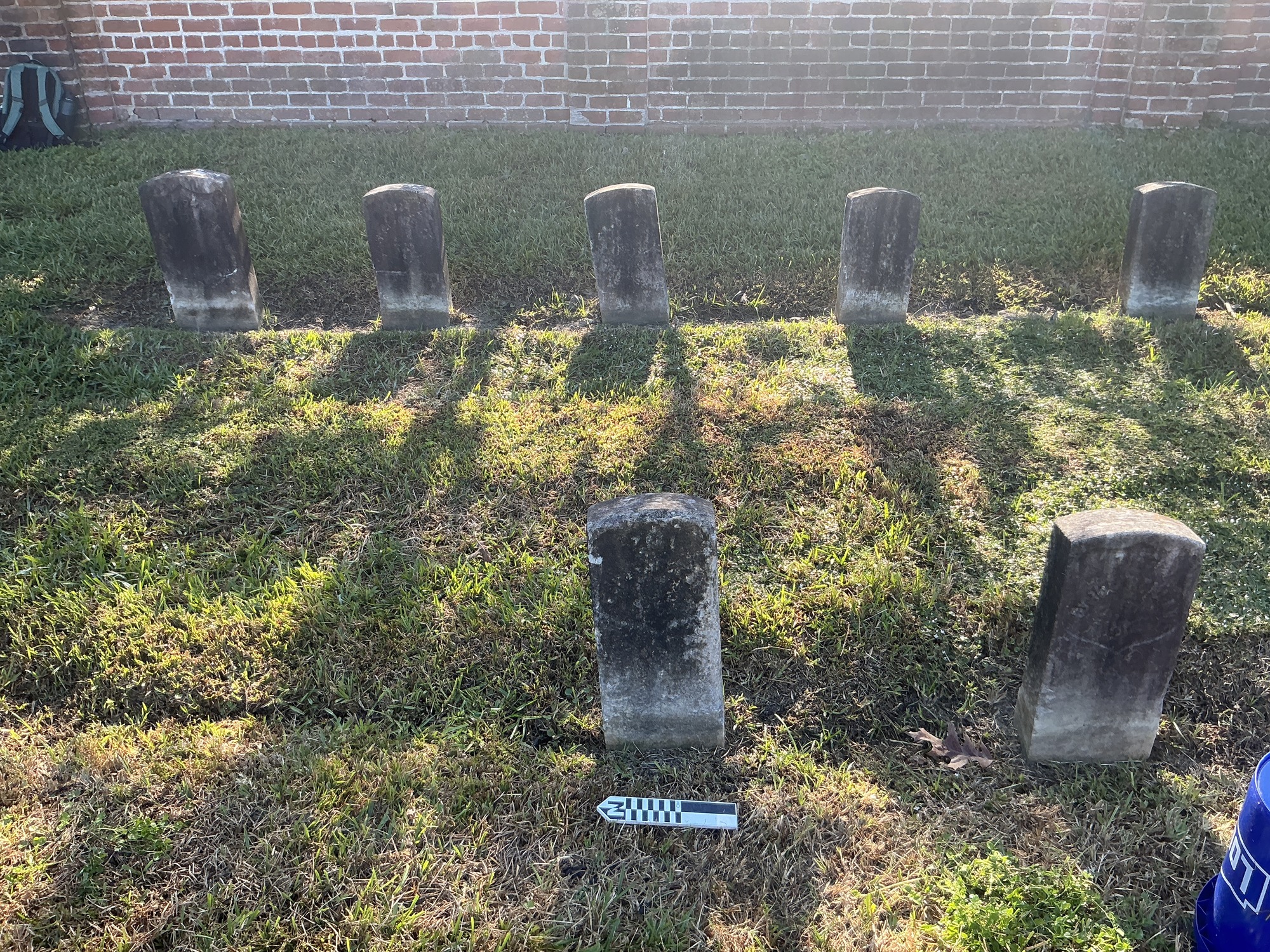 Extra image of historic upright marble headstone with recessed shield face.