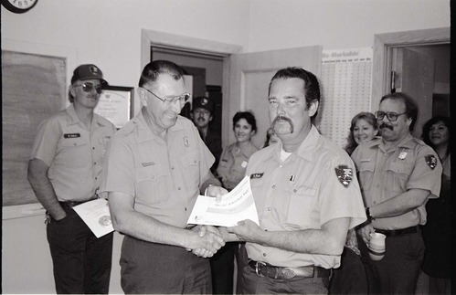 BW Photos of Superintendent Harold Grafe giving out awards to park personnel.
