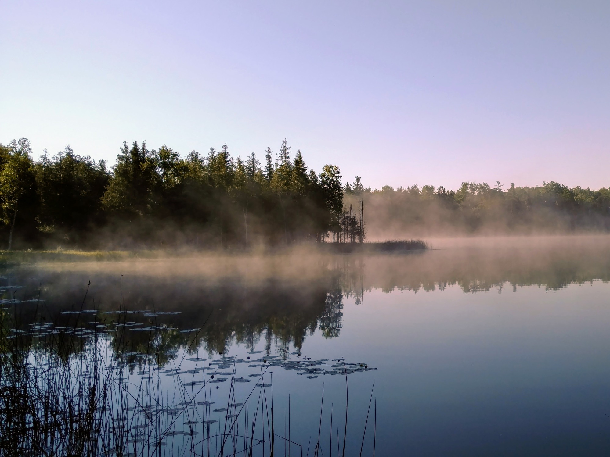 A lake with fog in the distance