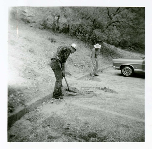 Workers shoveling dirt from parking lot of the old Mission 66 Visitor Center and Museum.