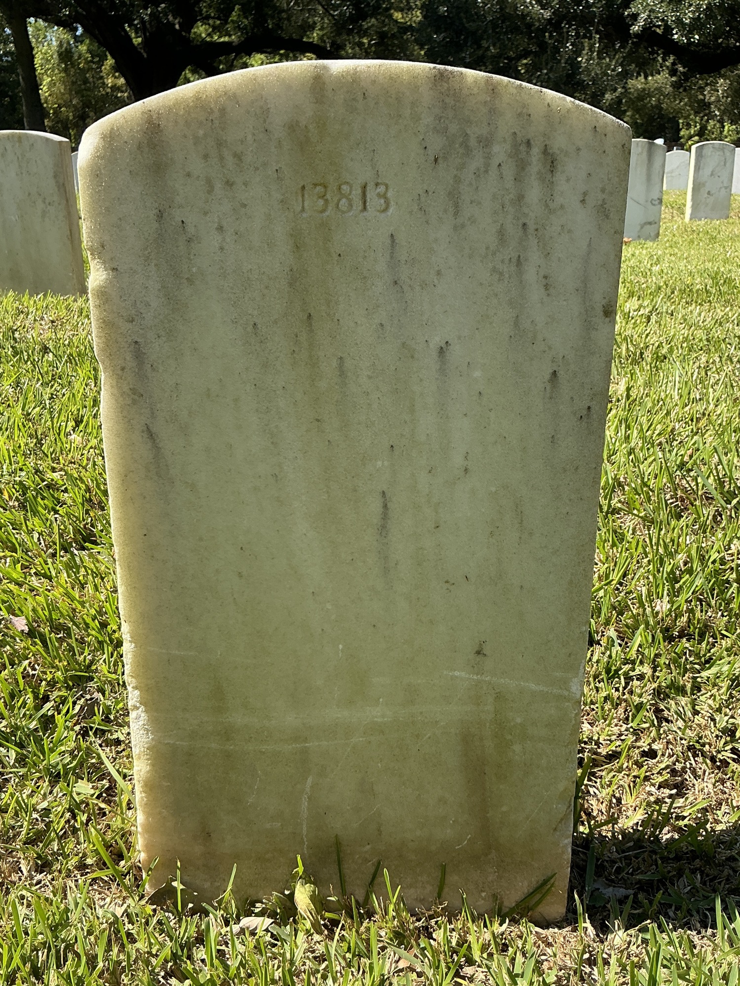 Back of upright marble headstone with flat face.