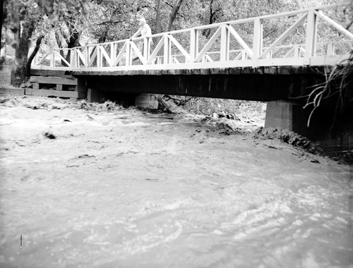 Person on the bridge at high water near Watchman residence area. September 17, 1961 is called the Great Flood of September which claimed 5 lives in the Narrows.