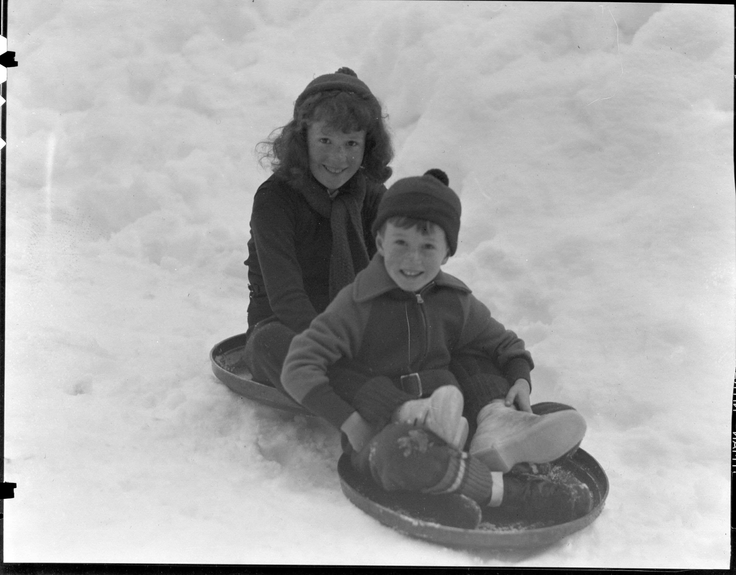 Youngsters on Ash Can and building snowmen (children of Dr. F.S. Durie, Superintendent)