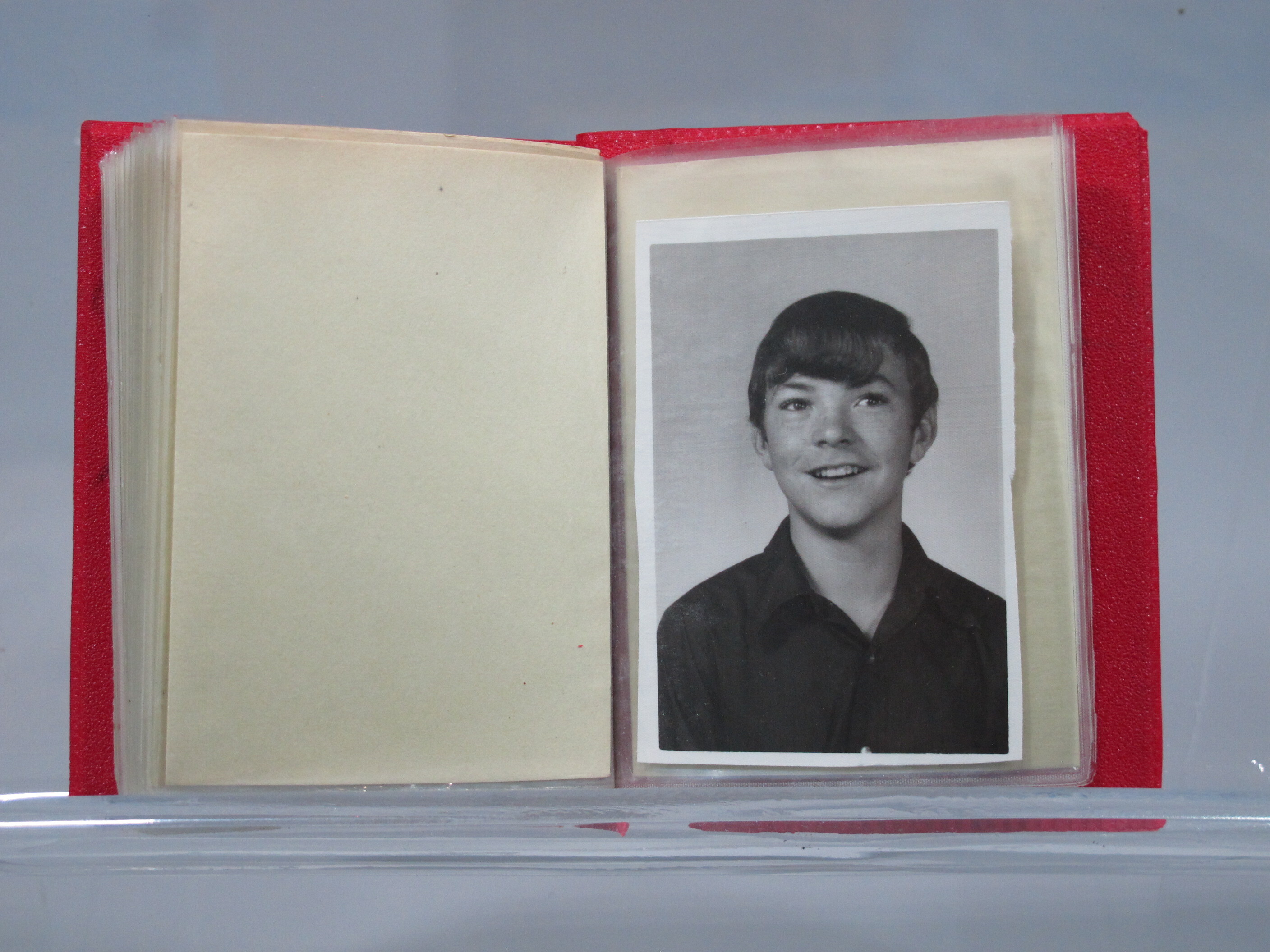 Souvenir photo album containing photographs and newspaper clippings related to Charles George Rehberger (KIA 03/02/1968). The cover is made of red plastic and says "Album" in raised black and tan print. Charles' name is written on the inside cover. Inside the album are 24 pages of plastic sleeves, holding 23 photographs, four news clippings, one funeral card, one rank insignia (Private), and one folded letter.

The first few pages of the album are images or clippings about Sgt Rehberger. The other images in the album depict others, possibly family members.