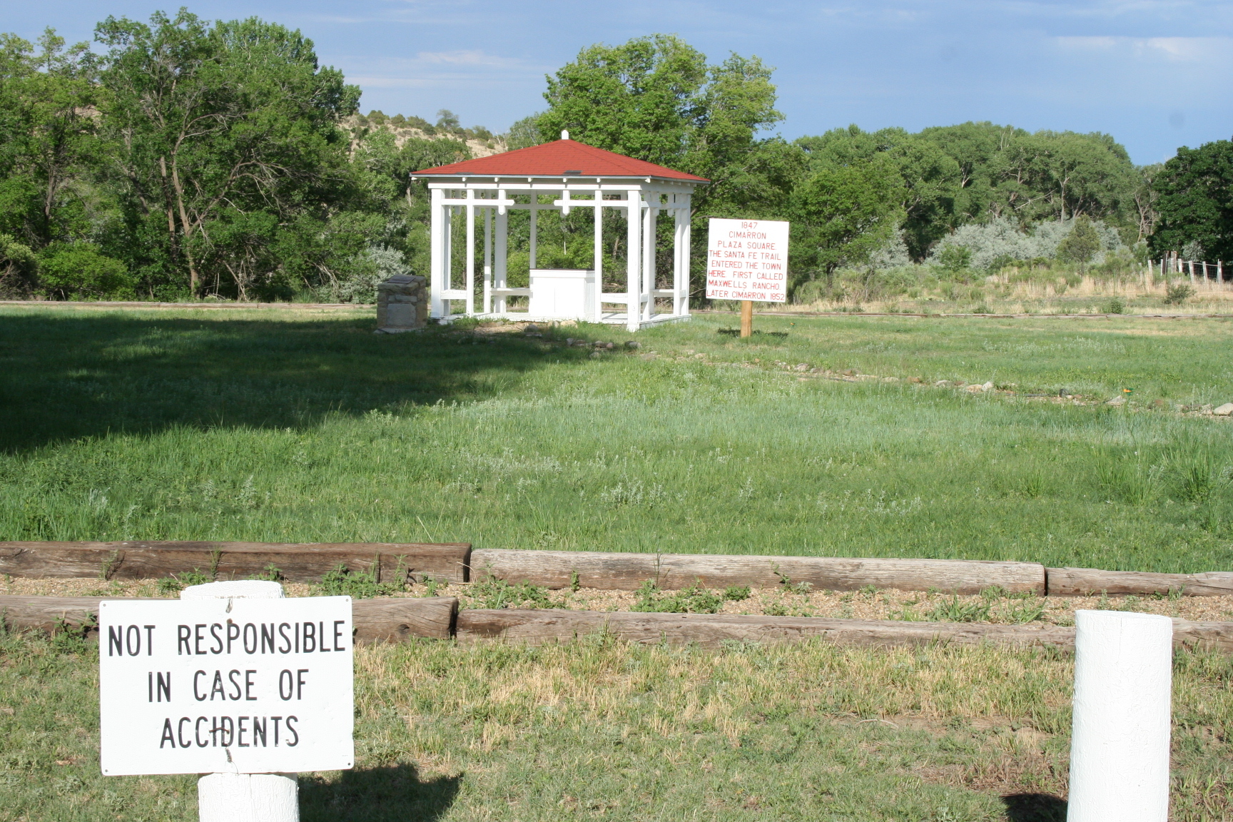 A gazebo in the middle of a grassy field.