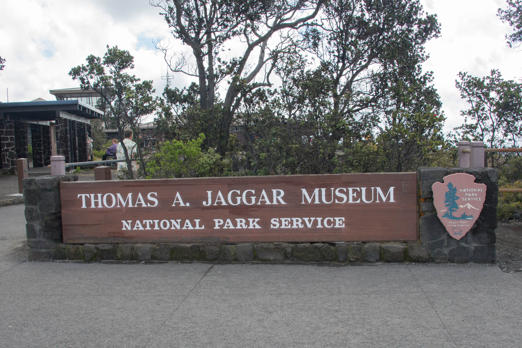 A large wooden building identity sign with text, "Thomas A. Jaggar Museum, National Park Service."