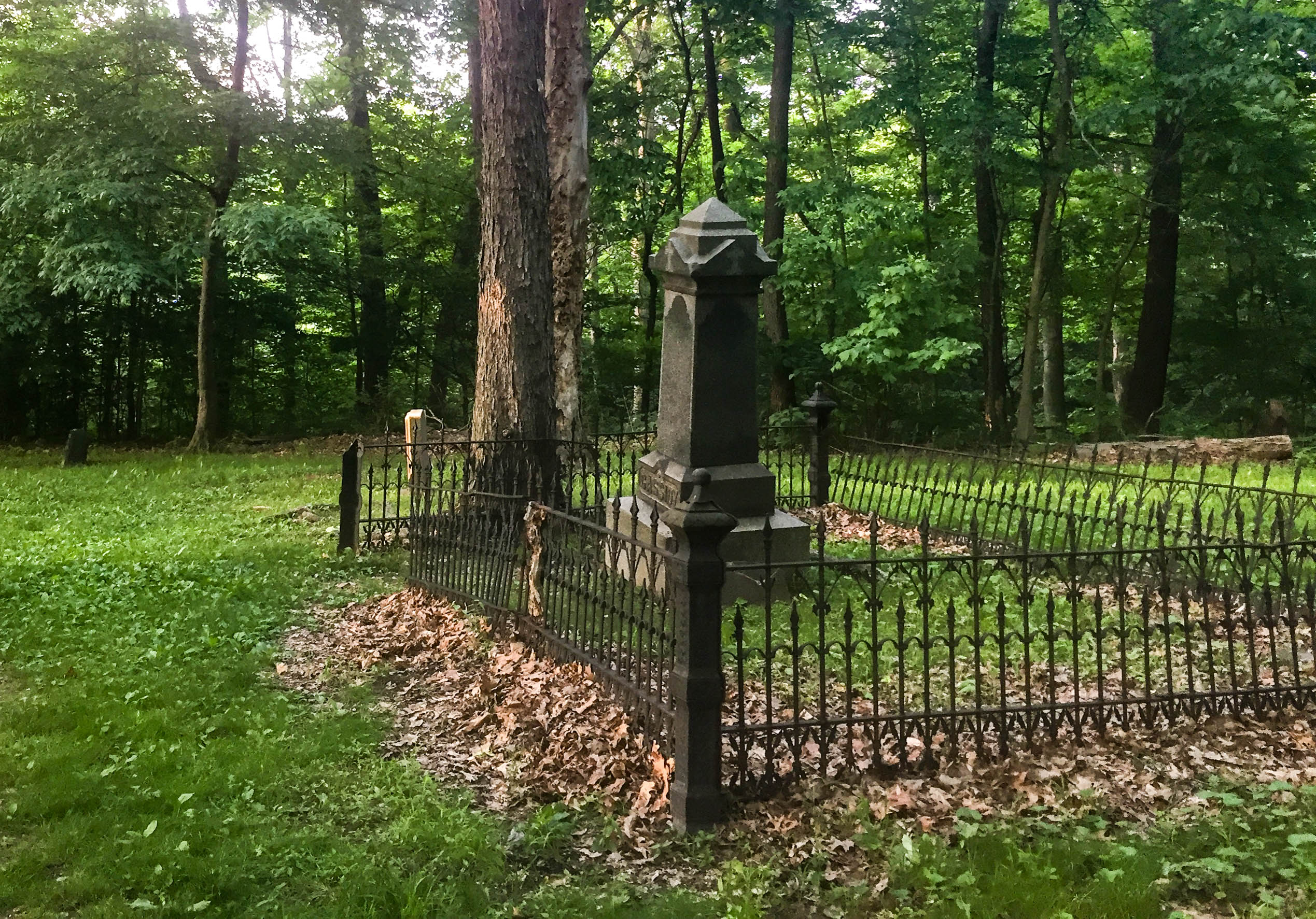 Stone marker surrounded by an iron fence