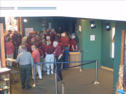 A group of people wait in line to see the original Homestead Act.