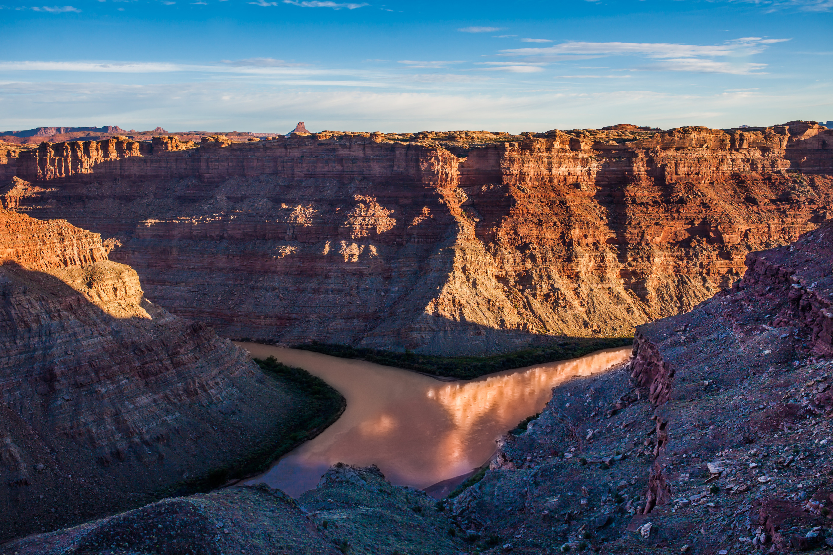 two rivers converge beneath tall canyon walls