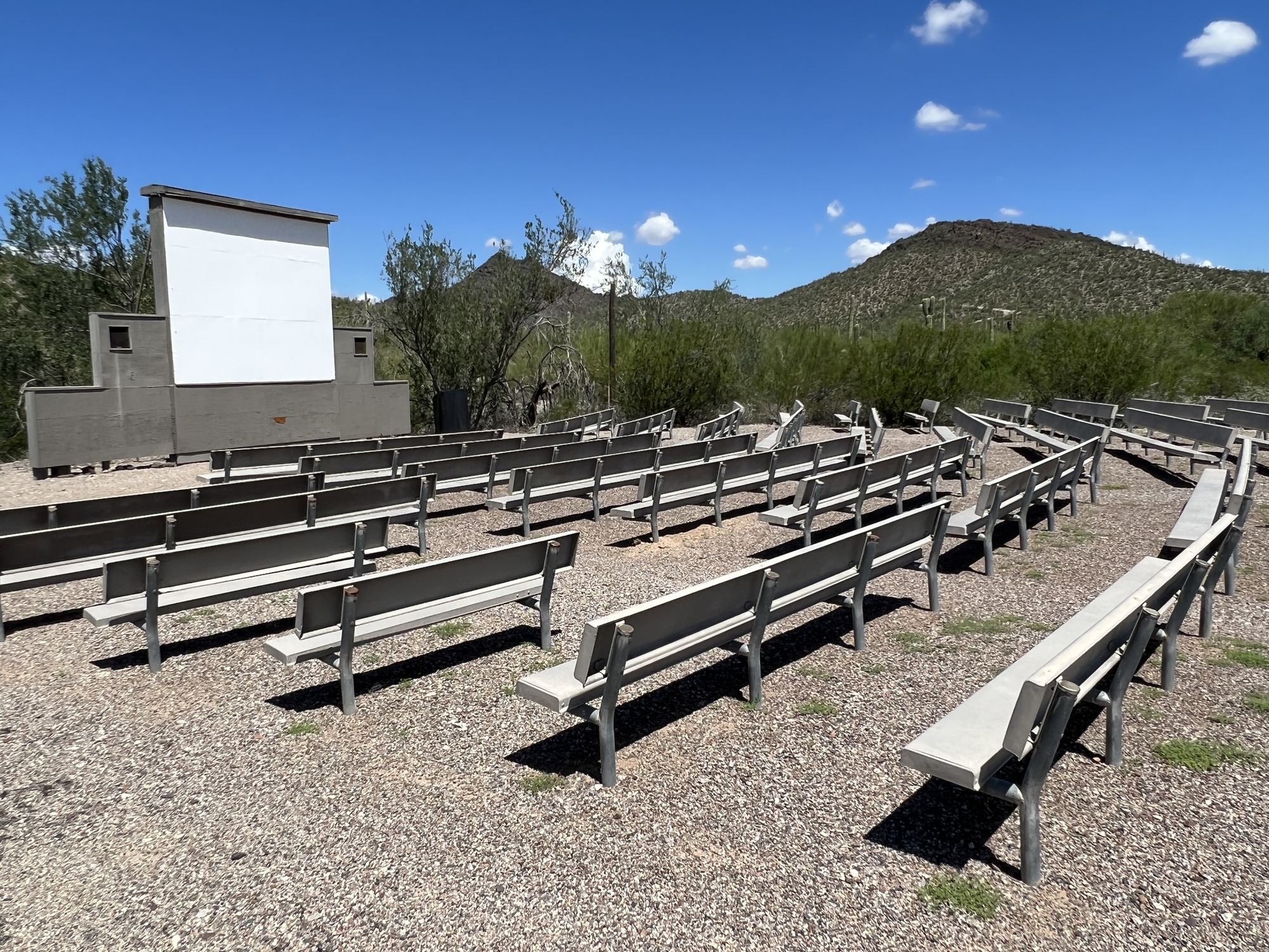 The Twin Peaks Amphitheater screen and seating area with a mountain in the background.