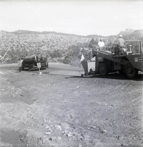 Men operating construction vehicle during chipsealing of Kolob Canyon Road.