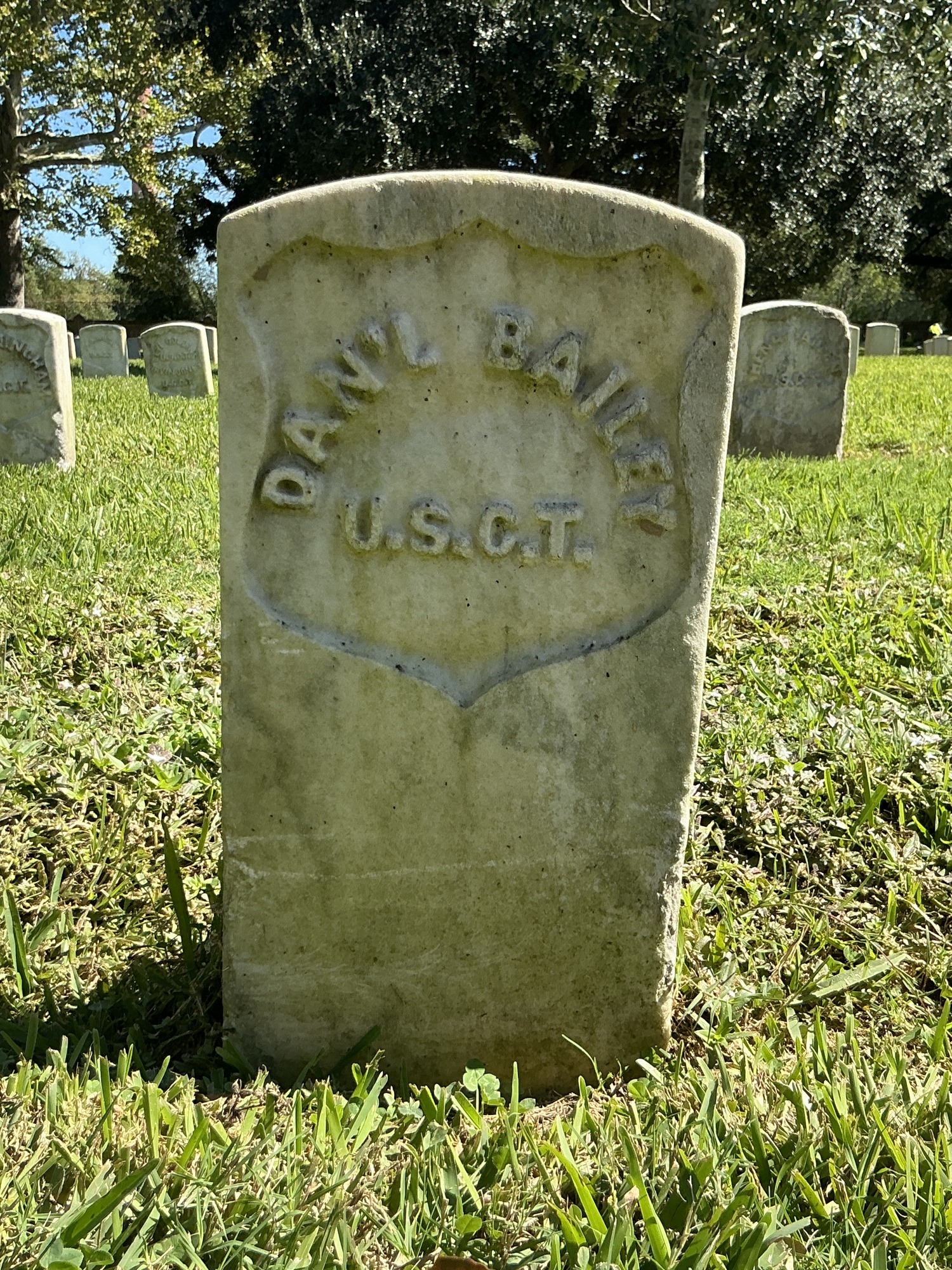 Back of historic upright marble headstone with recessed shield face.