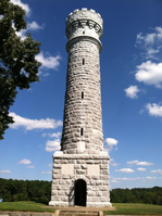 A tall stone tower standing against a blue sky