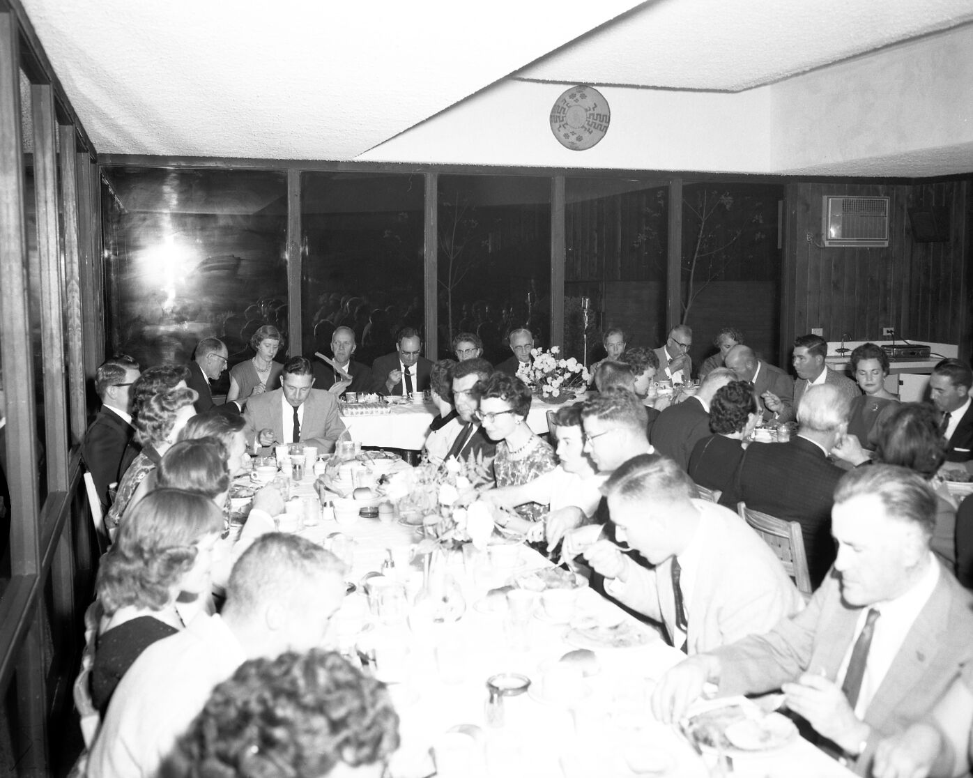 Men and women eating dinner at retirement party for Superintendent Paul R. Franke. Party held at the Driftwood Lodge, Springdale, Utah.