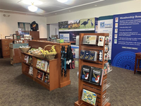 Merchandise from the park store on shelves and informational posters.
