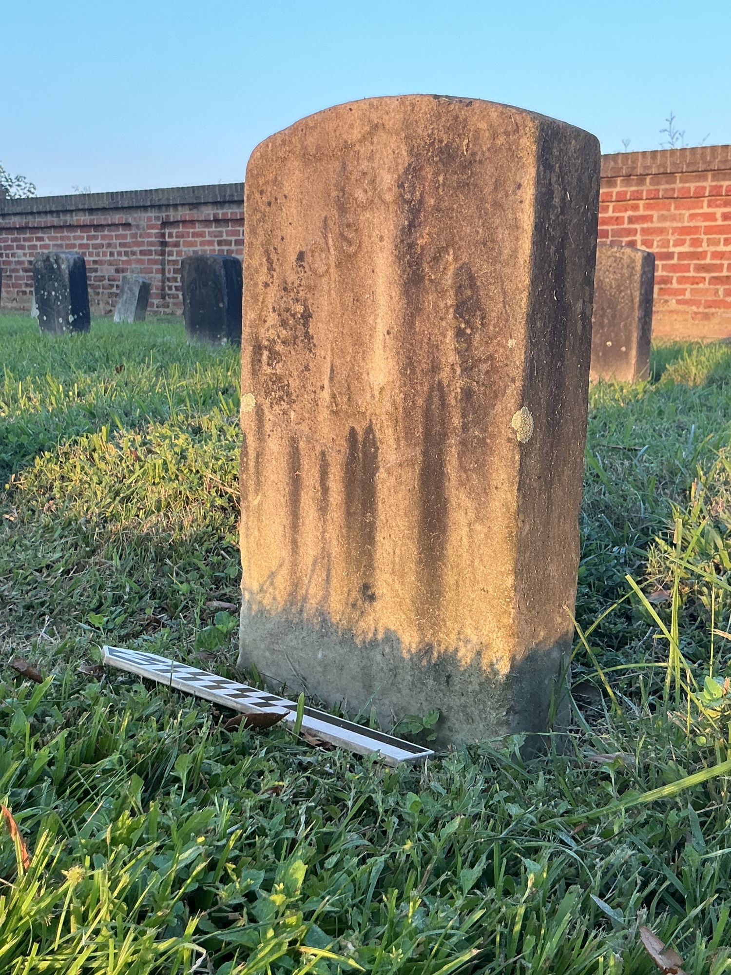 Extra image of historic upright marble headstone with recessed shield face.