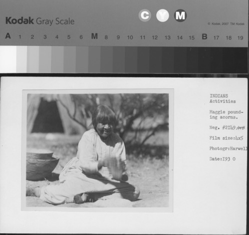 Maggie pounding acorns.