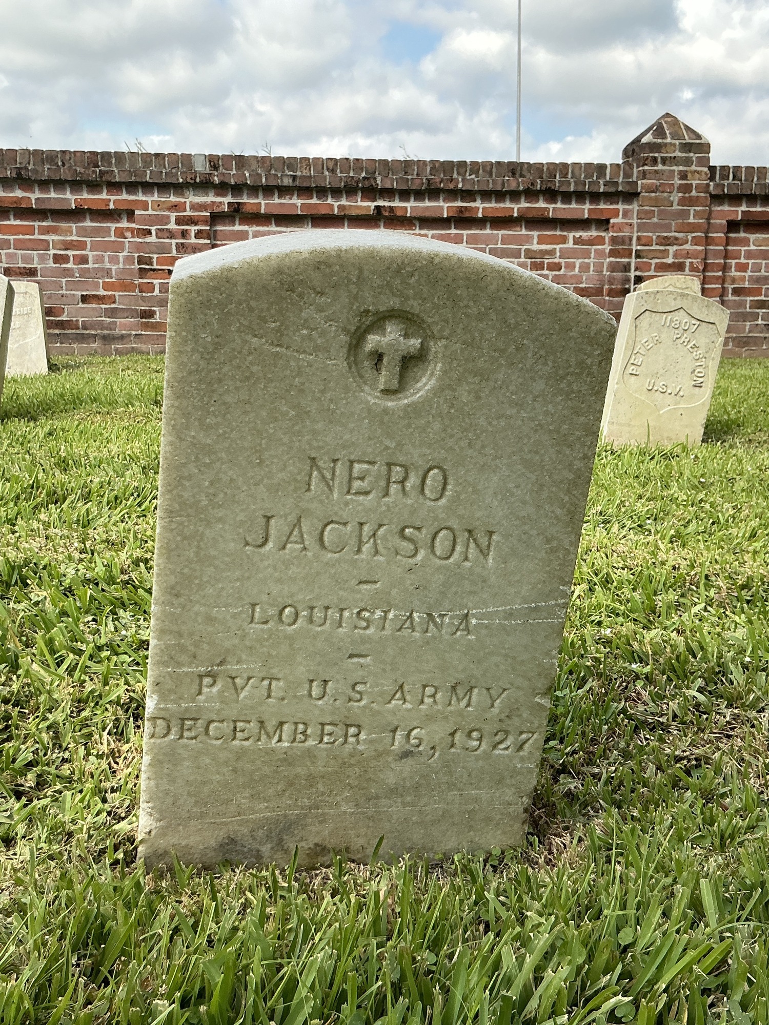 Front of upright marble headstone with recessed shield face.