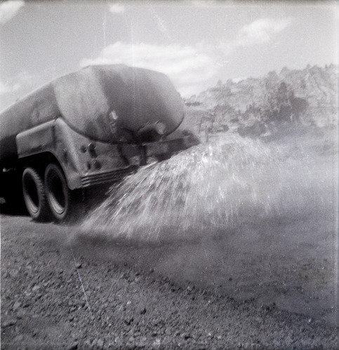 Construction vehicle spraying chipsealing of Kolob Canyon Road.