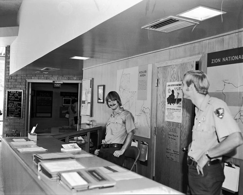 Student Conservation Association (SCA) volunteers Eric Thum and Ken Kertell (NPS) at Visitor Center information desk.