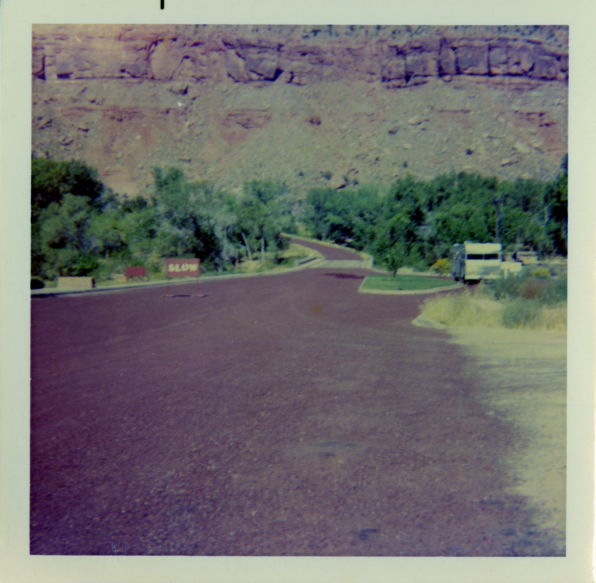 Roads with 'SLOW' sign and vehicle pull off on the right.