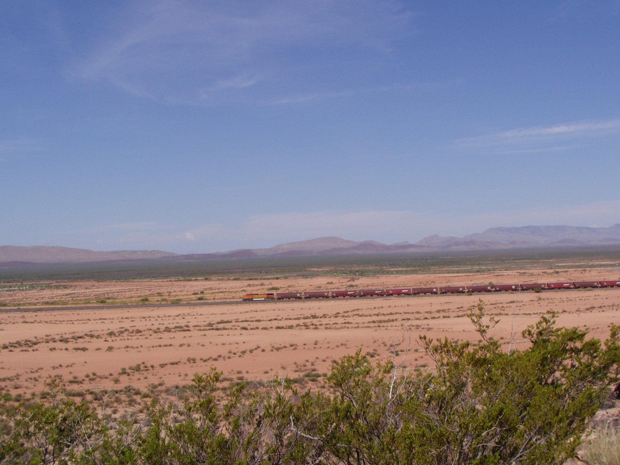 A train rumbles alongside the Jornada del Muerto trail in Sierra County, NM