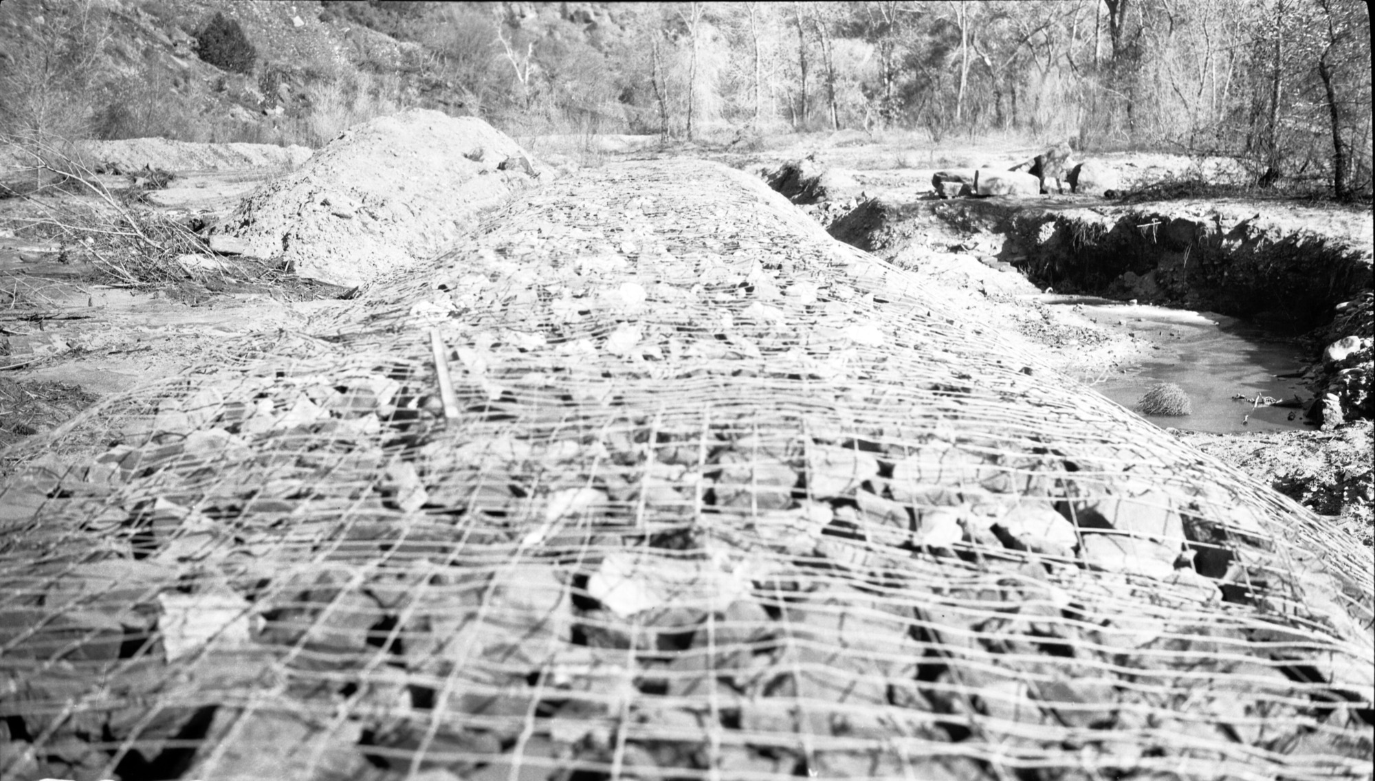 Basket dam #1, completed with the exception of back filling along toe of dam.