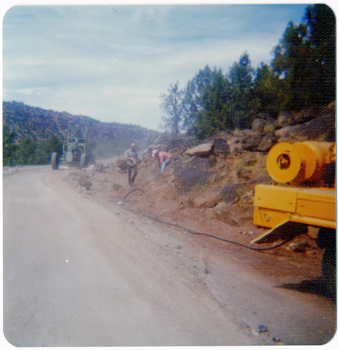 Men clearing rocks along the Kolob Terrace Road during construction.