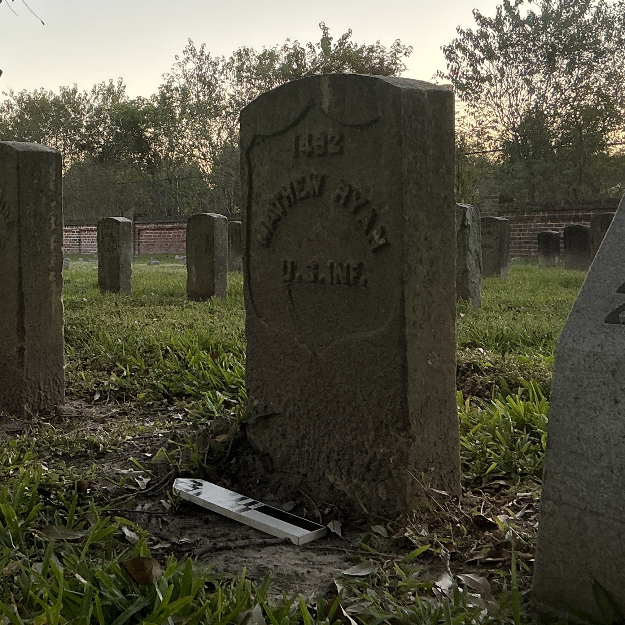 Extra image of historic upright marble headstone with recessed shield face.