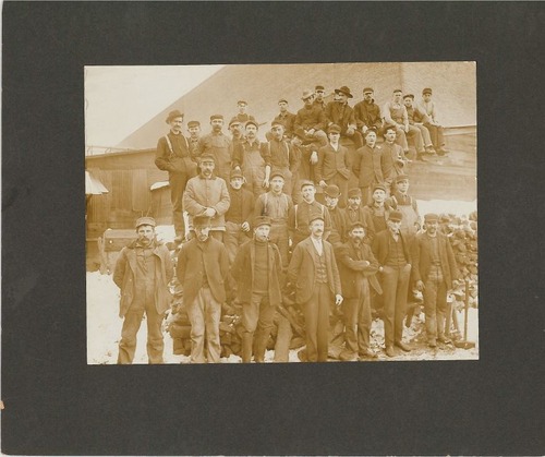 A large group of Dempster employees pose for a group photo outside. 